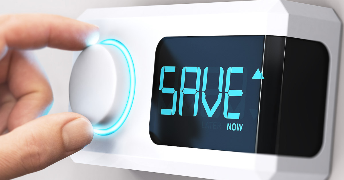 Person adjusting a digital thermostat with the word SAVE displayed on the screen.