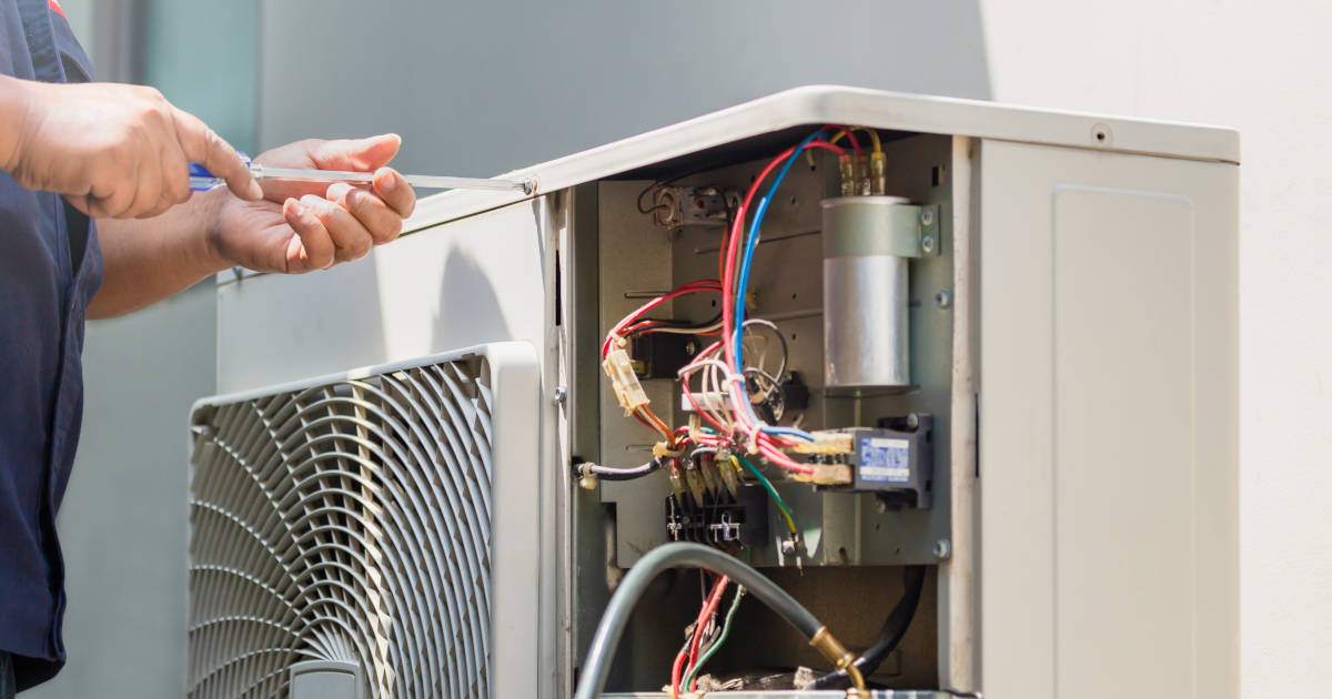 HVAC technician servicing an air conditioning unit