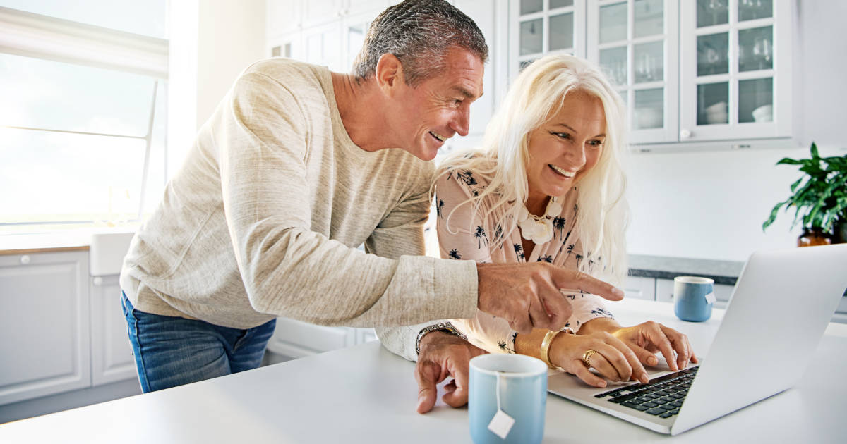 excited couple looking at computer